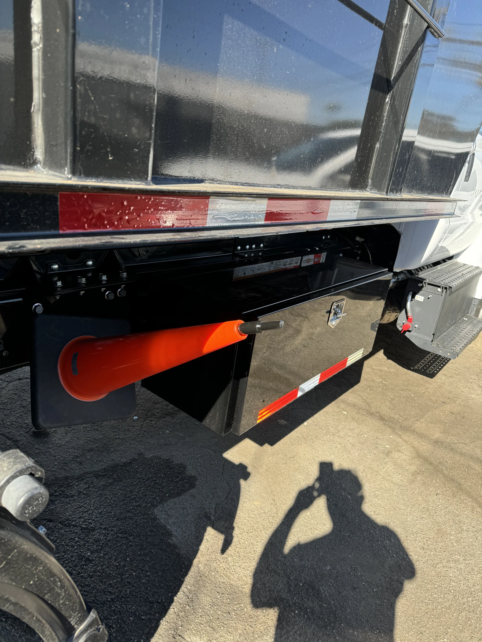 Black under-mount toolbox and safety cone holder installed on a work truck bed by A&R 1 Stop Shop