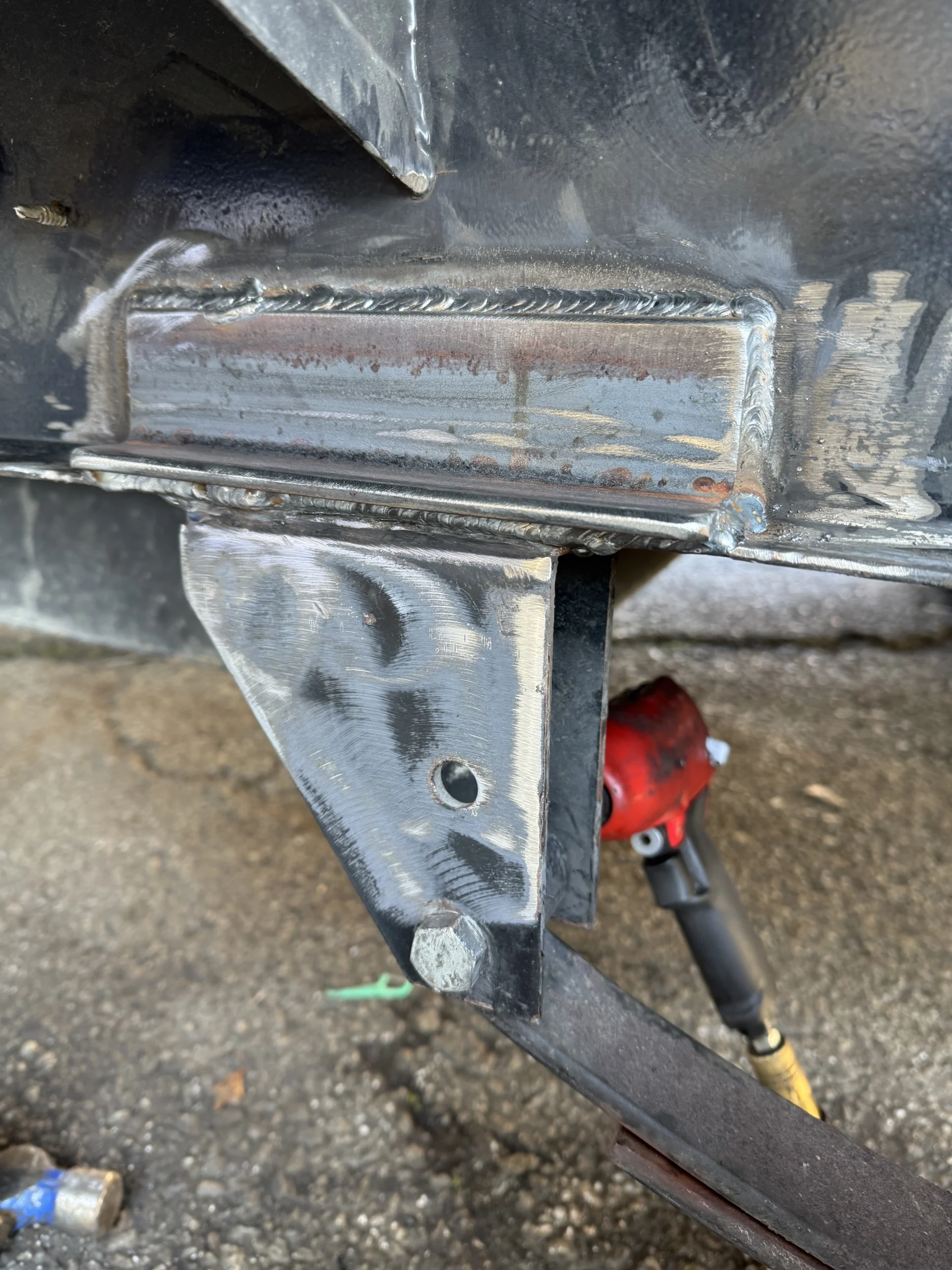 Welded repair on a trailer frame crossmember and gusset near the tongue jack